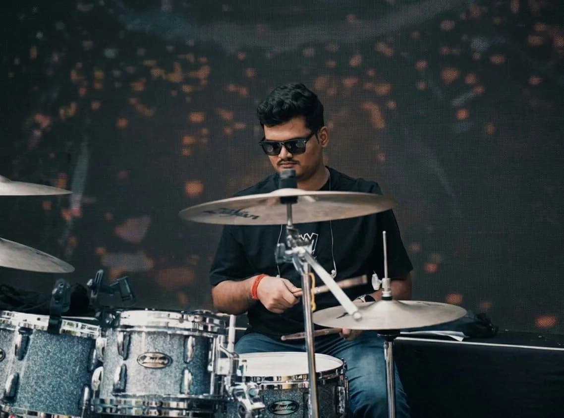 Softrock's drummer mid-groove behind a sparkle-finish kit.