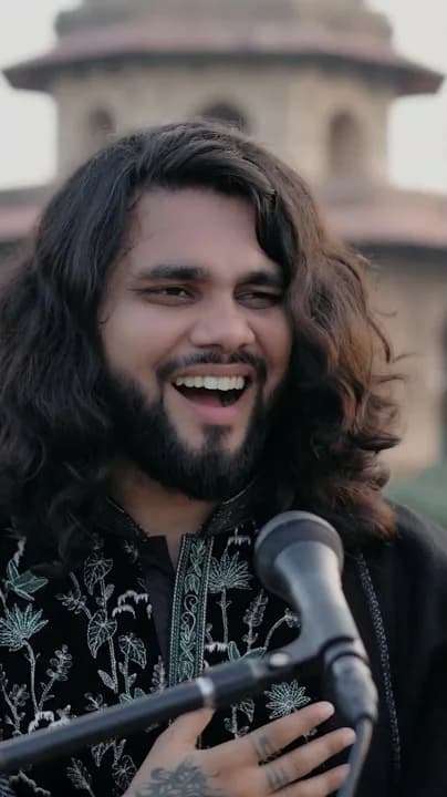 Close-up portrait of Softrock's vocalist laughing at the microphone.
