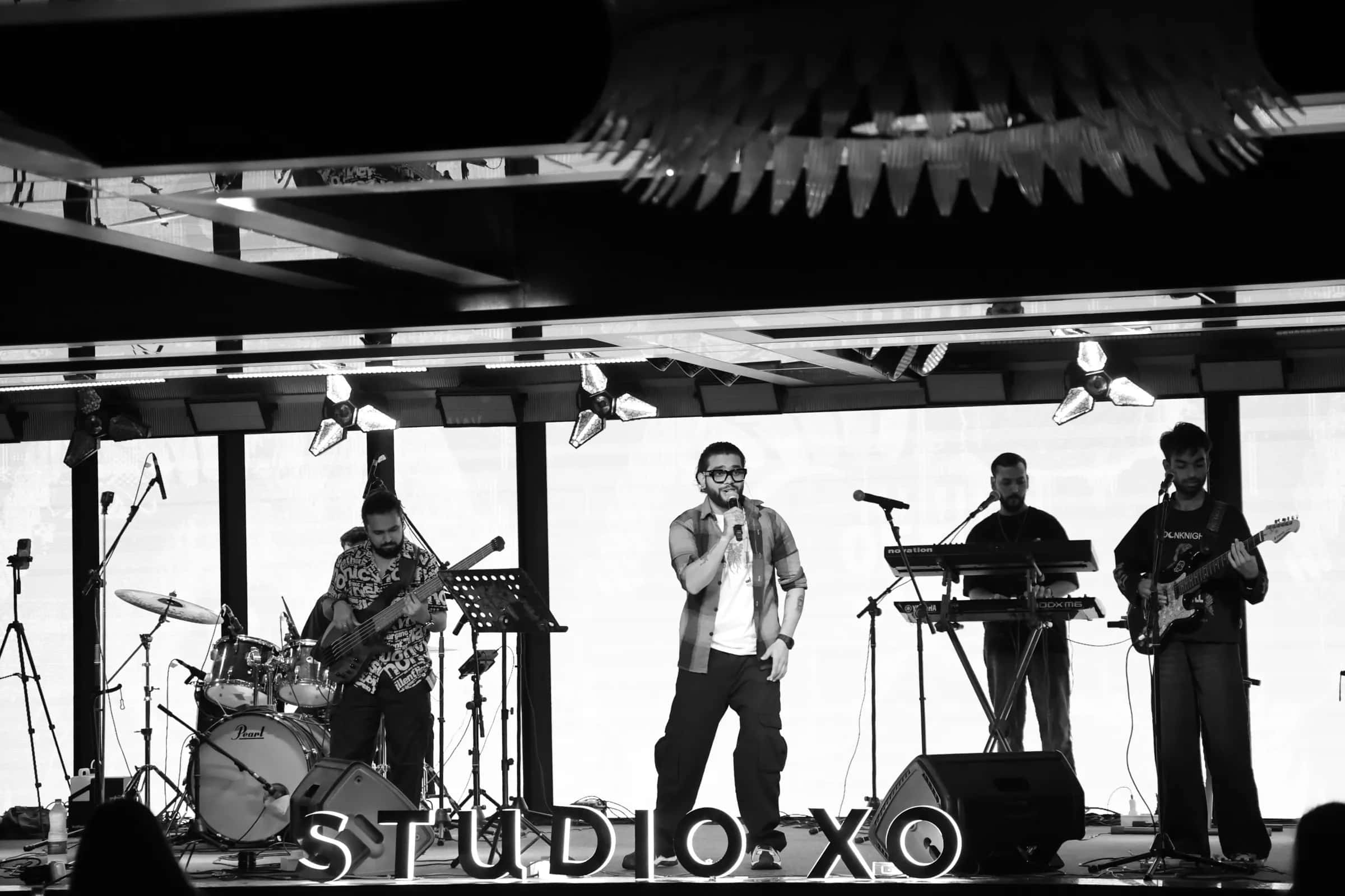 Black-and-white wide shot of the full Softrock line-up on the Studio XO stage.
